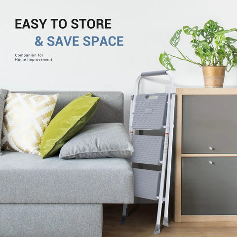 Three Step Stool With Anti Slip Pedals And Comfortable Handrail, Heavy Duty Portable Step Ladder stored next to a sofa