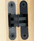 Concealed Black Finish Cabinet Hinge For Inset Doors With Three Eighths Inch Wings And One And Eleven Sixteenths Inch Long Installed