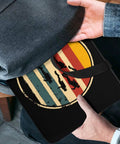 Hands placing a Watertight Scuba Inspired Laptop Tote Bag With Heavy Duty Padding For 12 Inch Laptops into a backpack.