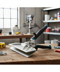 9-inch zinc-alloy hand seamer with teal grip on a wooden workbench for bending and folding metal sheets