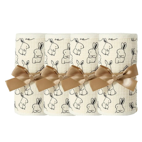 Breathable Cotton Gauze Bed Rail Teething Protector with bunny design, wrapped with brown ribbon, for baby crib sides.