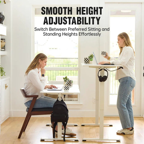Two women using 47.2 Inch Electric Standing Desk With Wood Desktop Height Adjustable Sit Stand Workstation in white finish