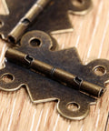Close-up of 20 Piece Butt Hinge Set With Screws In Antique Bronze Finish For Wooden Jewelry Boxes Cabinets Doors And Wine Cases 25 By 20 mm