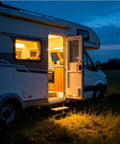 Rock Solid Rv Power Converter And Battery Charger 55 Amp 120V Ac To 12V Dc Plug And Play Multi Stage Smart Charging For Lithium And Lead Acid Batteries Built Tough outdoor RV at night with illuminated entrance and kitchen area.