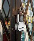 Magnum Heavy Duty Solid Steel Padlock With Key For Outdoor Gates And Sheds on metal gate, showing beefy security and cut-resistant shackle.