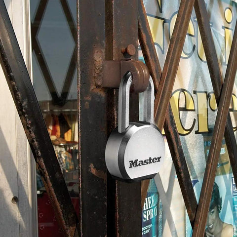 Magnum Heavy Duty Solid Steel Padlock With Key For Outdoor Gates And Sheds on metal gate, showing beefy security and cut-resistant shackle.