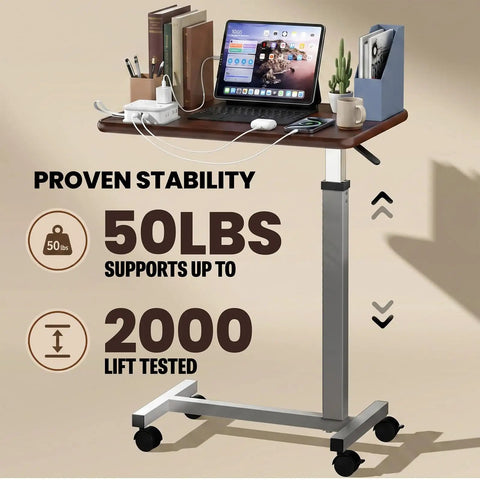 Heavy Duty Pneumatic Overbed Bedside Table With No Sweat Height Adjustment For Home Recovery Or Healthcare Use Non Tilt Surface Durable Walnut Cart with laptop and books.