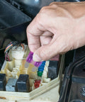 Hand replacing fuse in car with 100-Piece Auto Fuse Kit With Tall And Low-Profile Fuses And Circuit Tester, Plug-and-Play Quick-Replace