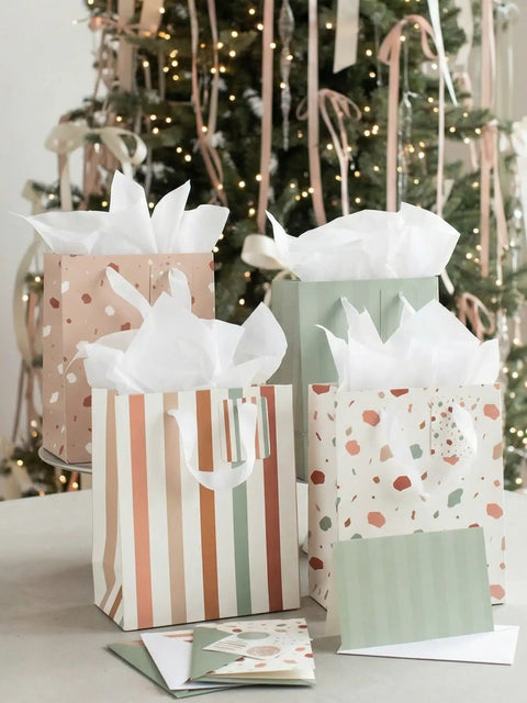Grab And Go Medium Sized Gift Bag Set With Handles, 9 Inch, Includes Matching Tissue Paper, Cards, Stickers, And Envelopes, Reusable Gift Wrapping Kit For Birthdays, Weddings, Mother's Day Or Any Occasion displayed in front of a decorated tree.