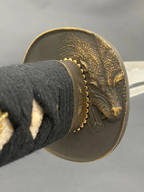 Close-up of Katana Iaito Training Sword With Unsharpened Aluminum Alloy Blade's ornate tsuba with wolf design.