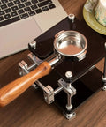 Straight Up Espresso Tamping Station For Home Baristas, 58mm Acrylic Portafilter Holder, wooden handle on sleek black tamping stand.