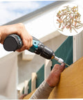 Hand using a drill to install Heavy Duty Metal Self Drilling Expansion Screws Drywall Wall Anchors 50 Piece Rock Solid Mounting Kit.