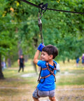 Child using Heavy Duty Zip Line Pulley Kit With Six Steel Rollers For Backyard Adventure, easy install, supports up to 440 lbs
