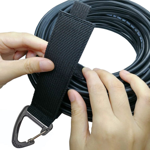 Hands using Eight Piece Heavy Duty Cable Organizer Set For Garage And Workshop Storage With Durable Straps Holds Cables Hoses And Ropes