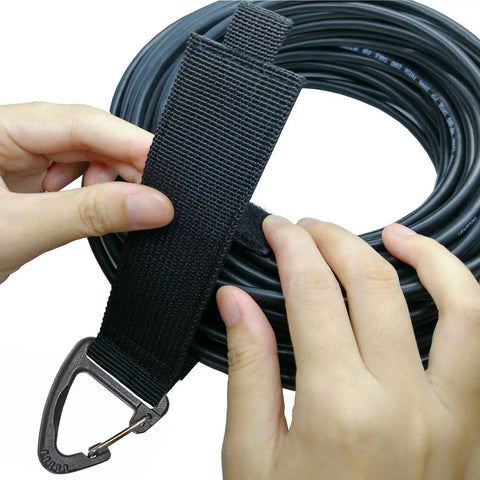 Extension Cord Organizer With Carabiner 8 Pack for Garage and Shop Storage being used to secure a coiled cable.