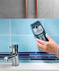 Person using Heavy Duty Stud Finder Wall Scanner With Snappy Metal And AC Wire Detection to locate pipes in a tiled wall.