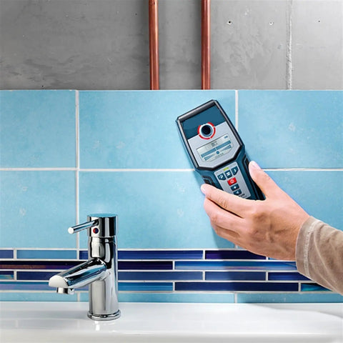 Person using Heavy Duty Stud Finder Wall Scanner With Snappy Metal And AC Wire Detection to locate pipes in a tiled wall.