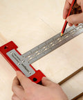 Heavy Duty Scriber T Square Ruler With Support Lips And Built In Scribe Notches Crafted From Rock Solid 301 Stainless Steel Plus Sturdy Aluminum Handle To Nail Every Carpenter Layout Job And Architectural Plan 12 Inch being used to mark lines on wood.