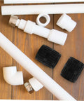 Top view of Tubing Deburring Reamer Set 2 Pcs Inner Outer Reamer Tool among various pipe fittings on a wooden surface.