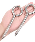 Hand holding Two Pack 6 Inch Heavy Duty Screw Eyes Hooks In 304 Stainless Steel Self Tapping Eye Bolts For Wood And Securing Wires And Cables