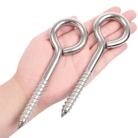 Hand holding Two Pack 6 Inch Heavy Duty Screw Eyes Hooks In 304 Stainless Steel Self Tapping Eye Bolts For Wood And Securing Wires And Cables