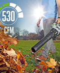 Person using Cordless Electric Leaf Blower With Battery, Turbo Mode, 110 MPH Air Speed, 530 CFM in a yard scene