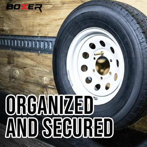 Heavy Duty E Track Spare Tire Mount With 5 Inch Bolt Hanger For Enclosed Trailers Trucks Semis And Garages Built To Last Holds Spare Tight Spring Loaded Grip Easy Wall Mount installed holding a tire on a wall