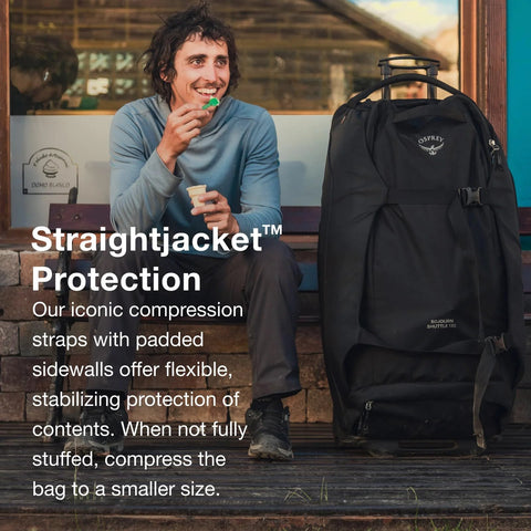 Black Osprey Sojourn Shuttle wheeled duffel bag with extendable trolley handle, front view.
