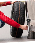Person installing spare tire with Spare Tire Hold Down Bolt And Retainer Clamp For Car And Truck Wheel Easy To Install Replacement Tire Bolt Secures Spare Tire To Prevent Bouncing Durable Steel Construction For Road Trips And Daily Driving.