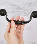 Hand holding 6 Pack Vintage Antique Black Drawer Pulls Handles With 5.5 Inch Hole Center And 6.7 Inch Total Length Made From Zinc Alloy