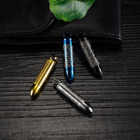 Gold Bullet Pendant Necklace With Engraved Cross And Bible Charm Premium Stainless Steel Unisex Jewelry on a wooden surface.