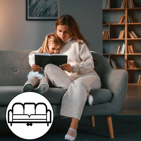 Mother and daughter reading on a grey couch, showcasing the need for 20 Pcs Heavy Duty Nylon Sectional Connectors Keep Your Couch Locked Down Tight Universal Sofa Brackets Stop Shifting And Gaps Super Easy Tool Free Install For Any Living Room Setup.
