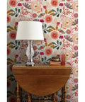 Wildflowers Floral Wallpaper Featuring Hella Smooth Matte Linen Texture And Truly PVC Free Composition Professional Grade Type II Paste Ready Wallcovering Super Durable Accent Decor For Modern Homes with lamp and wooden table.