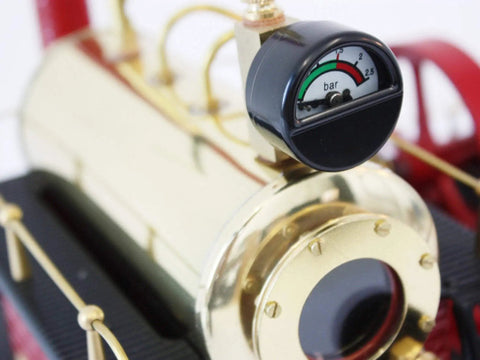 Close-up of D21 Steam Engine Model With Esbit Dry Fuel Burner TÜV Certified with gauge on metallic finish.