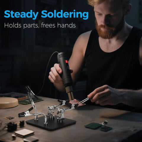 Man using Helping Hands Soldering Station with Rock Solid 3.9 Inch Base and four flexible magnetic arms for electronics work.