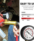 Backyard Mechanic Handheld Vacuum Pump Brake Bleeder Kit With Live Pressure Tester And Universal Gauge Adapters in use with gauge.