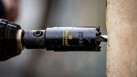 Close-up of Carbide Tipped Hole Saw With Premium Finish For Wood PVC And Fiberglass Four And Three Quarters Inch Diameter drilling wood