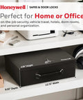 Compact Home Safe Box With Fire Resistant Insulation And Dual Key Lock Heavy Duty Steel Stash Safe For Jewelry Cash And Personal Documents 0.17 Cubic Feet Black on a shelf in an office setting.