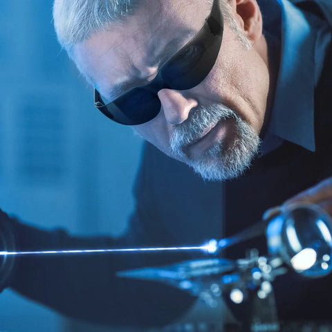 Man wearing Bulk 100 Safety Glasses Set For Men And Women Eye Protection Goggles with dark lenses in a lab setting