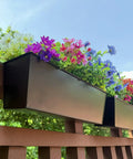 Set Of Four Heavy Duty Metal Railing Planters, 16 Inch Rectangular Window Boxes with colorful flowers on a wooden railing.