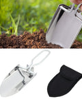Compact Folding Camping Shovel With Durable Stainless Steel Build For Outdoor Survival Mini Shovel For Hiking and trowel versatile entrenching tool with ergonomic handle and carrying pouch in silver used for digging in soil.