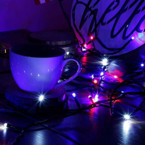Patriotic 200 LED 66Ft Fairy String Lights With 8 Lighting Modes illuminating a cup in red, white, and blue.