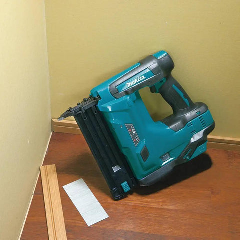 18V LXT Cordless 2-Inch Brad Nailer With 110-Nail Magazine in corner, trim work setup, gray handle, teal body