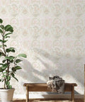 Living room with Pink Bohemian Damask Peel And Stick Wallpaper Removable Repositionable Boho Wall Covering For Easy DIY Decor No Glue Needed Mess Free 20.5 In By 16.5 Ft Made In The USA Great For Accent Walls And Furniture Refresh behind a bench and plant.