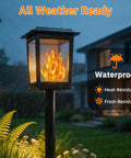 Gen2 Flickering Flame Solar Torch Lights 6 Pack Outdoor Waterproof Garden Decor Lamps in rainy yard with house