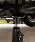 Adjustable Bottle Jack Axle Adapter for 2 to 12 Ton Jacks, black steel construction with 3 wing bolts, under vehicle view