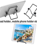 Black metal stands for iPad and phone displaying in various angles, one holding a tablet with a coastal image, labeled for devices.