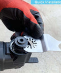 Hemunc oscillating multitool hook blade installed on the tool, silver metal, held by gloved hand.