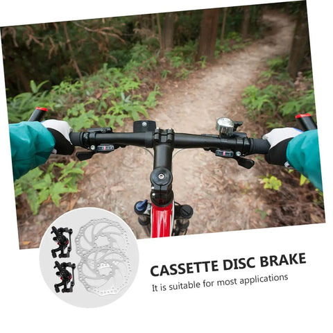 Image of Radical Performance Mechanical Disc Brake Set For Mountain Bikes. Front view of bike handlebars on a trail.