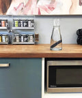Charcoal Water Purifying Stick from Kishu Japan for crisp, better-tasting water in glass carafe on kitchen counter